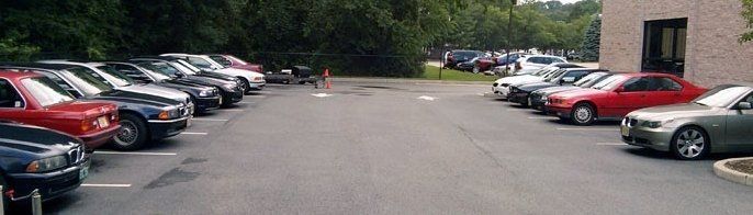 Cars parked in a parking lot next to a building.
