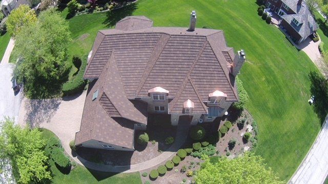 An aerial view of a large house in a residential area.