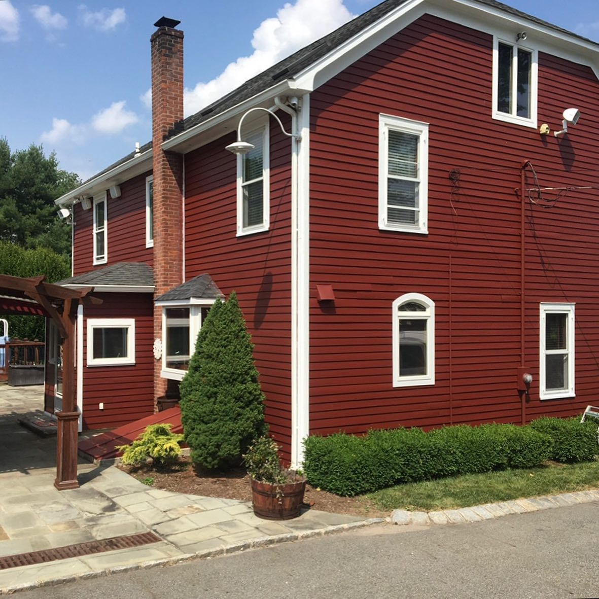 A red house with white trim and a chimney