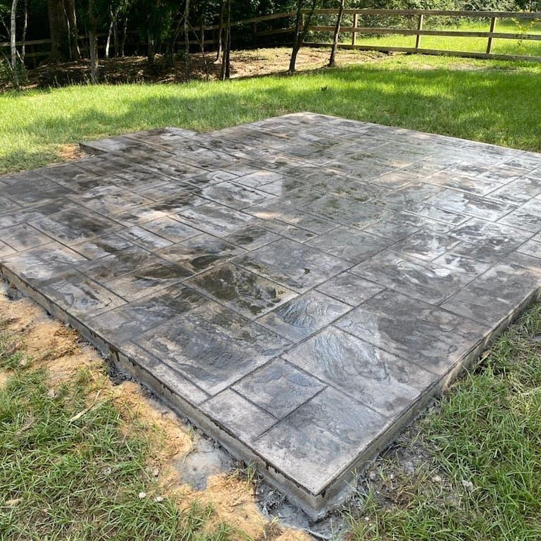 A concrete slab is sitting in the middle of a grassy field.