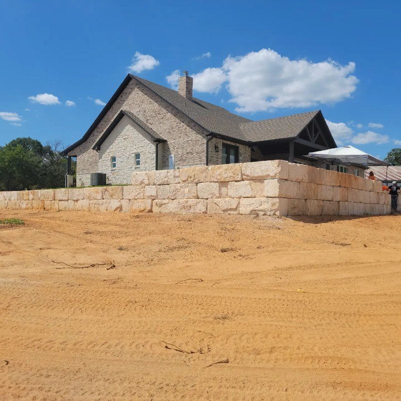 A house with a large stone wall surrounding it