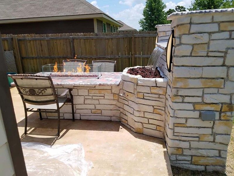 There is a fire pit in the middle of the patio.