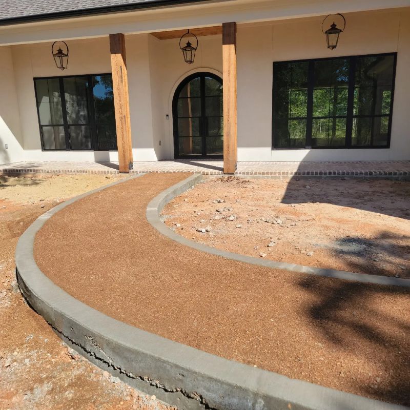 A house with a curved walkway in front of it