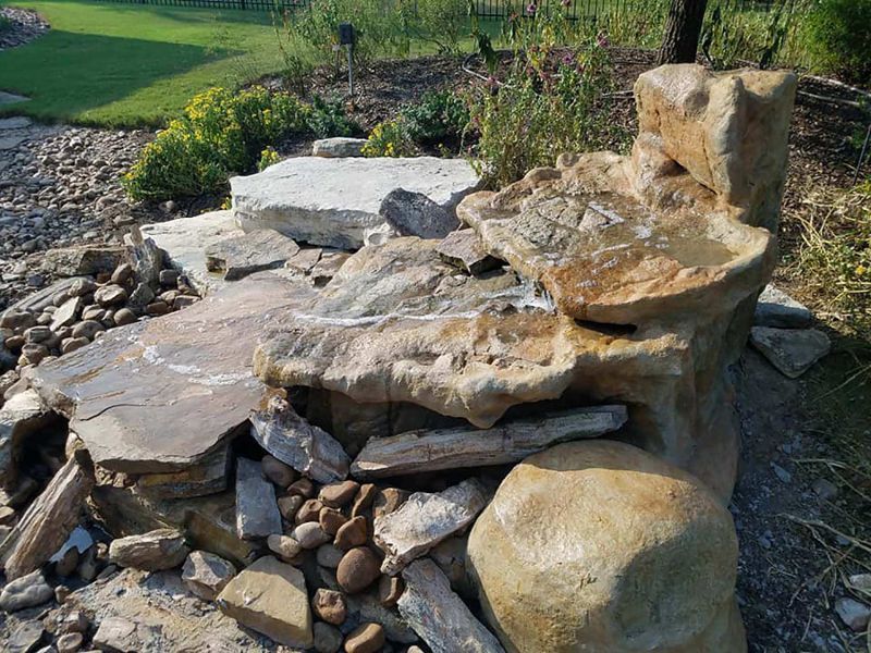 A waterfall made out of rocks in a garden.