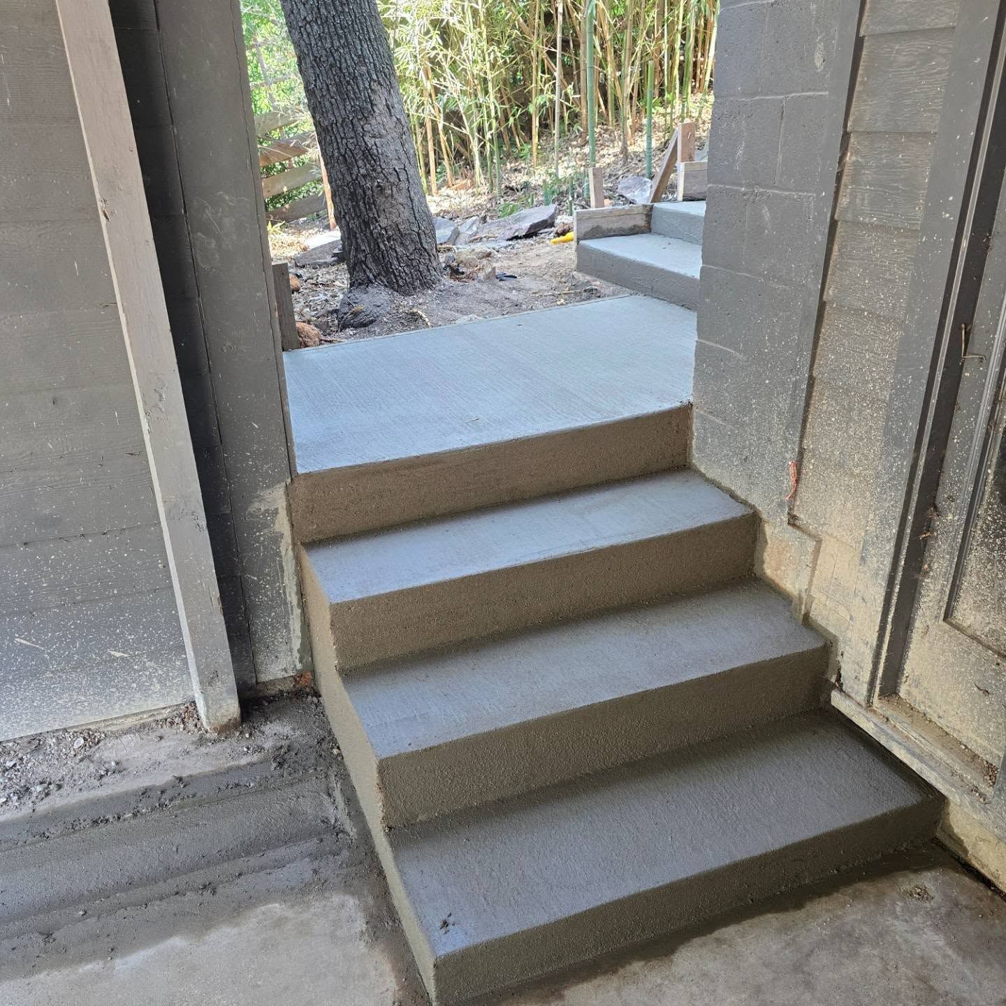 A set of concrete stairs leading up to a doorway.