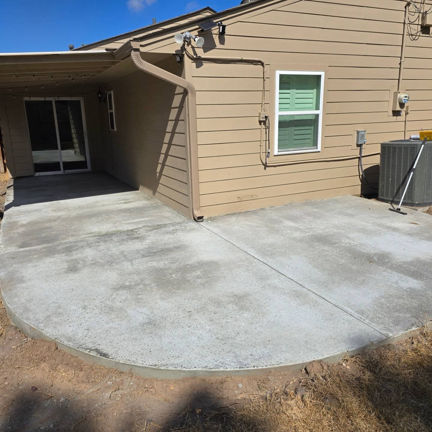 A house with a concrete patio in front of it