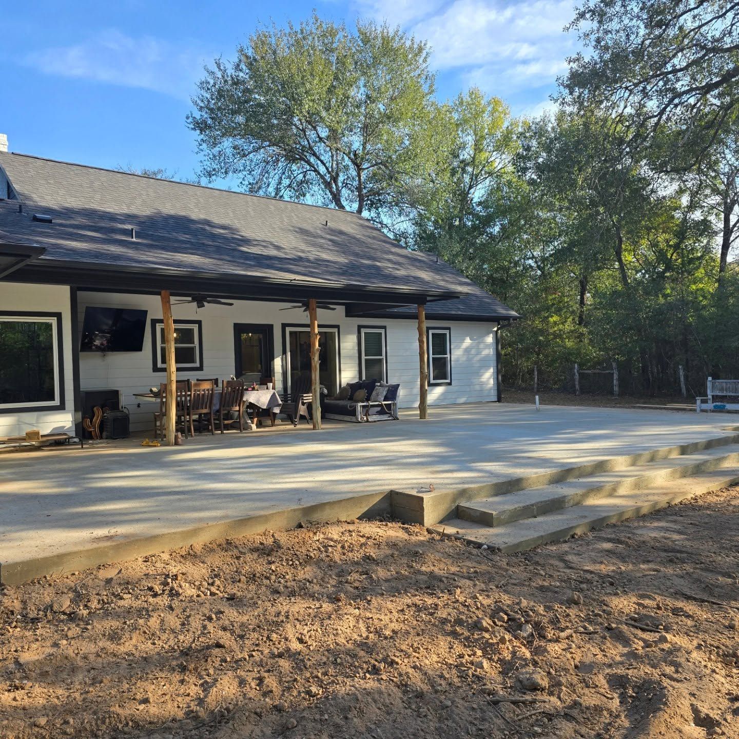 A house with a covered porch and a concrete patio