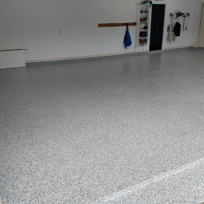 A garage with a gray floor and white walls.