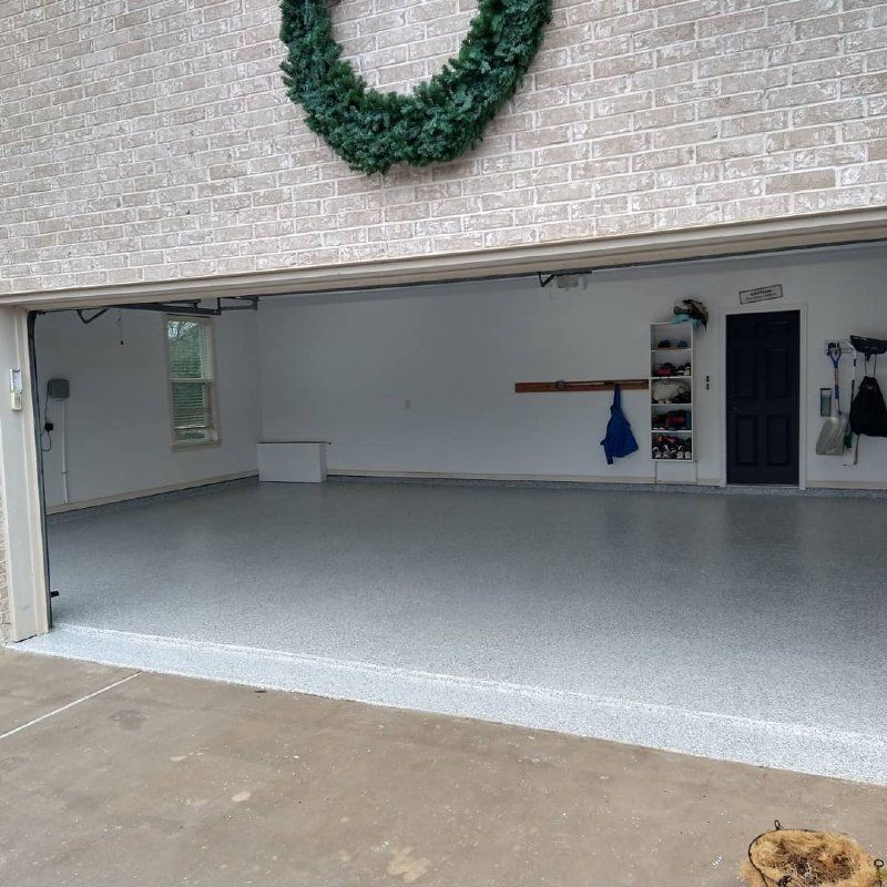 A garage with the door open and a wreath on the wall.