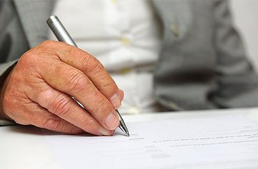 Older woman signing the document