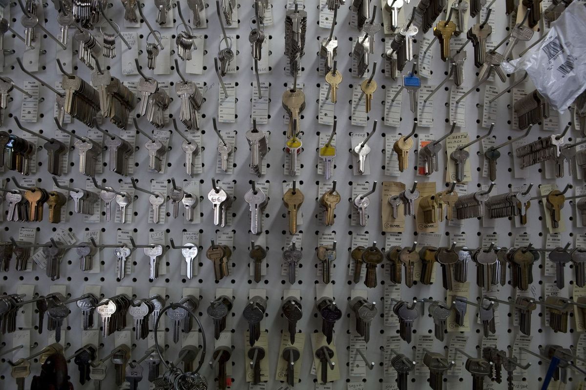 Wall of keys hanging on a pegboard, a locksmith's display of key types.