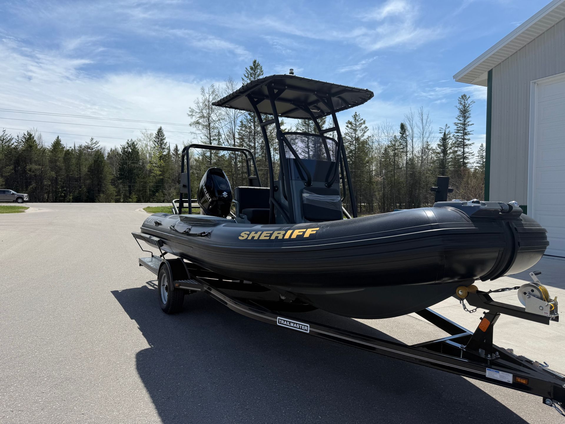 A dark sheriff's boat on a trailer. The boat is black with 
