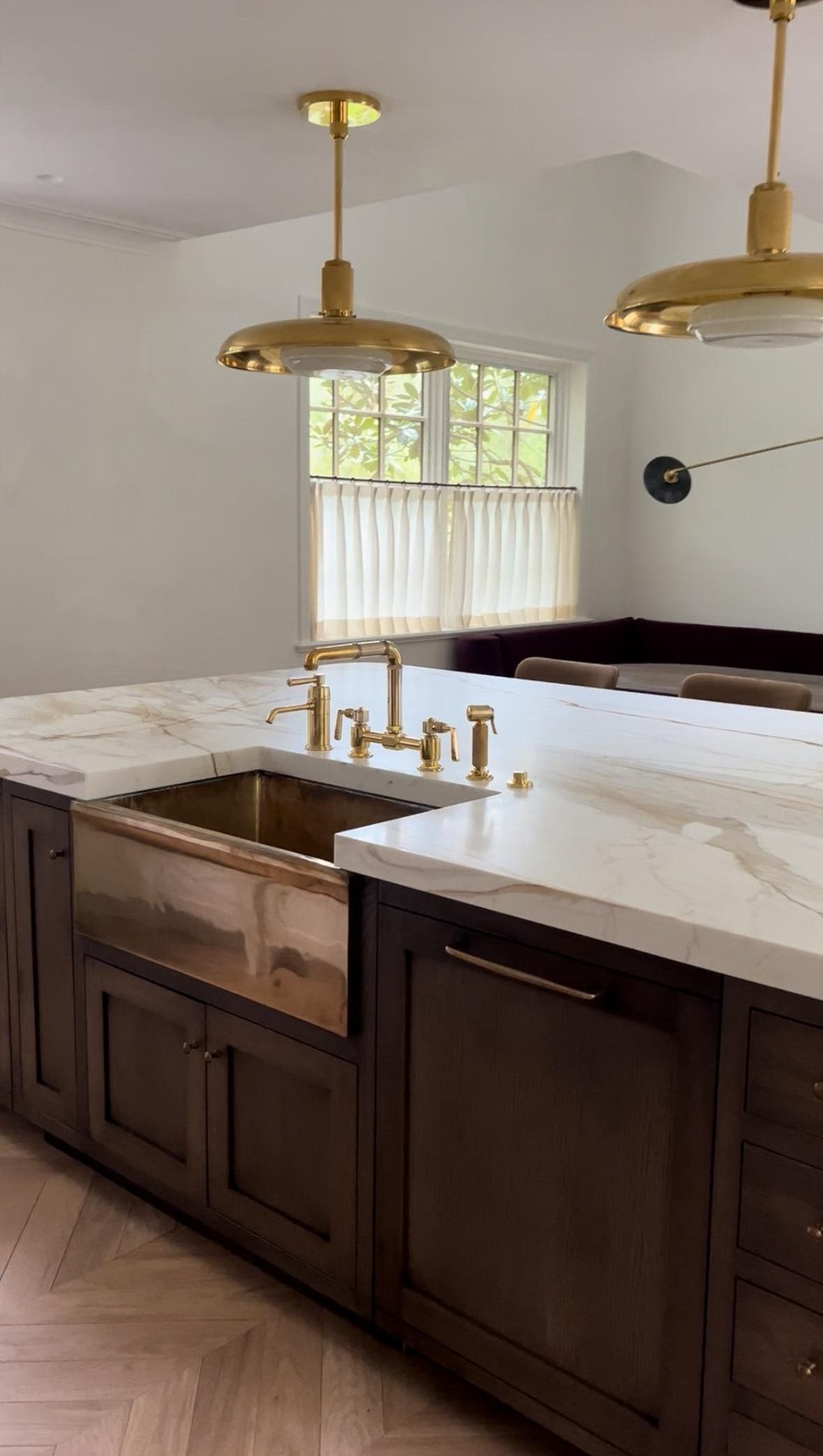 A kitchen with a large island and a sink.