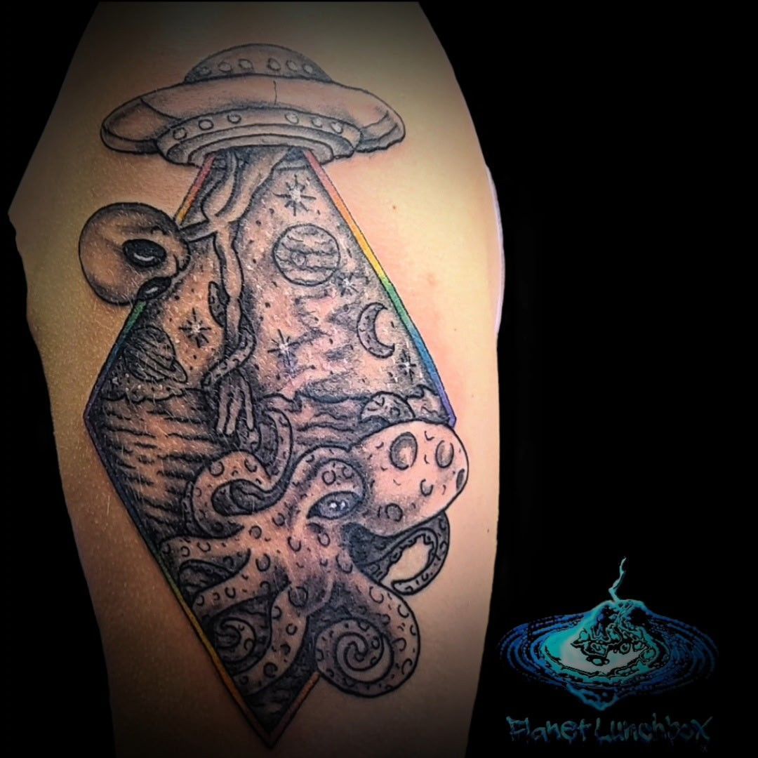 Black-and-gray tattoo of a mushroom with an octopus-like figure and tentacles on skin