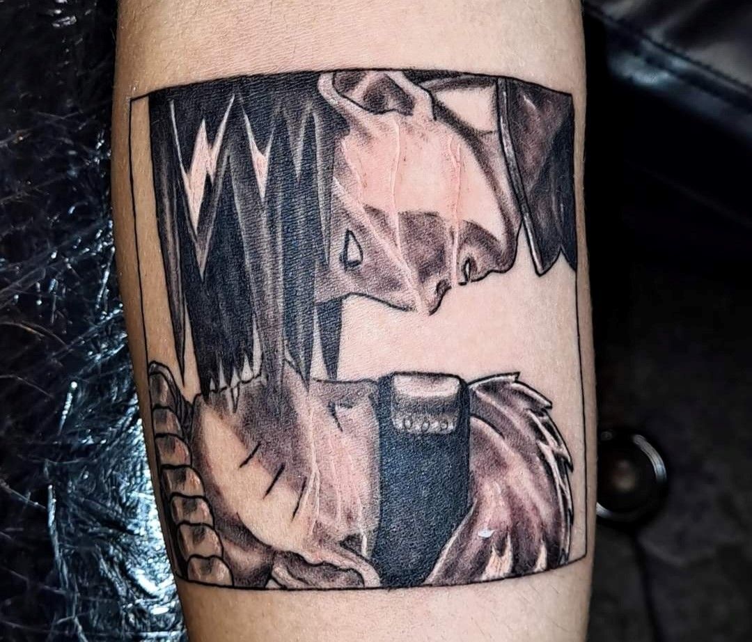 A black and white tattoo on a person's arm