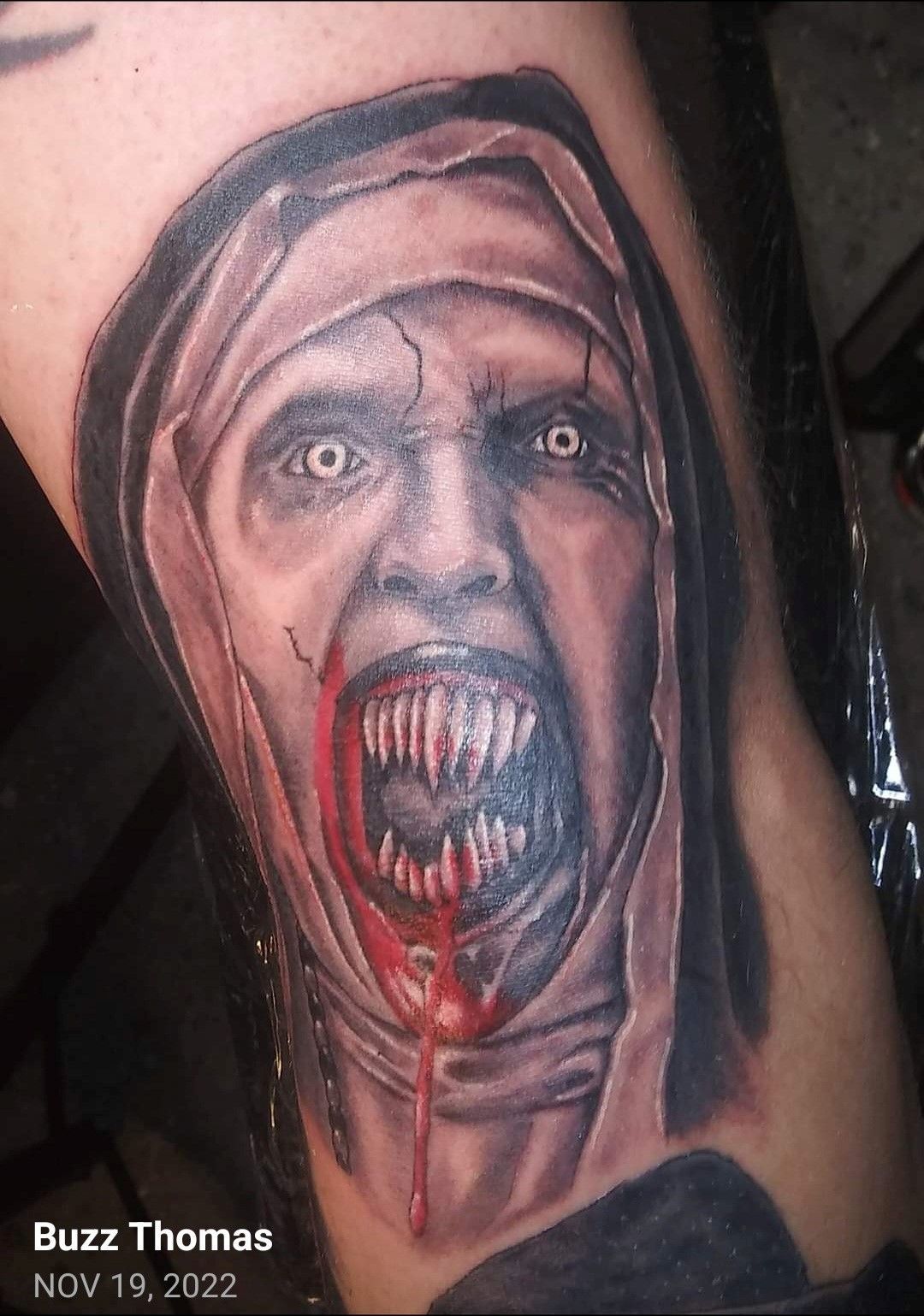 Buzz thomas took a picture of a tattoo on a person 's leg