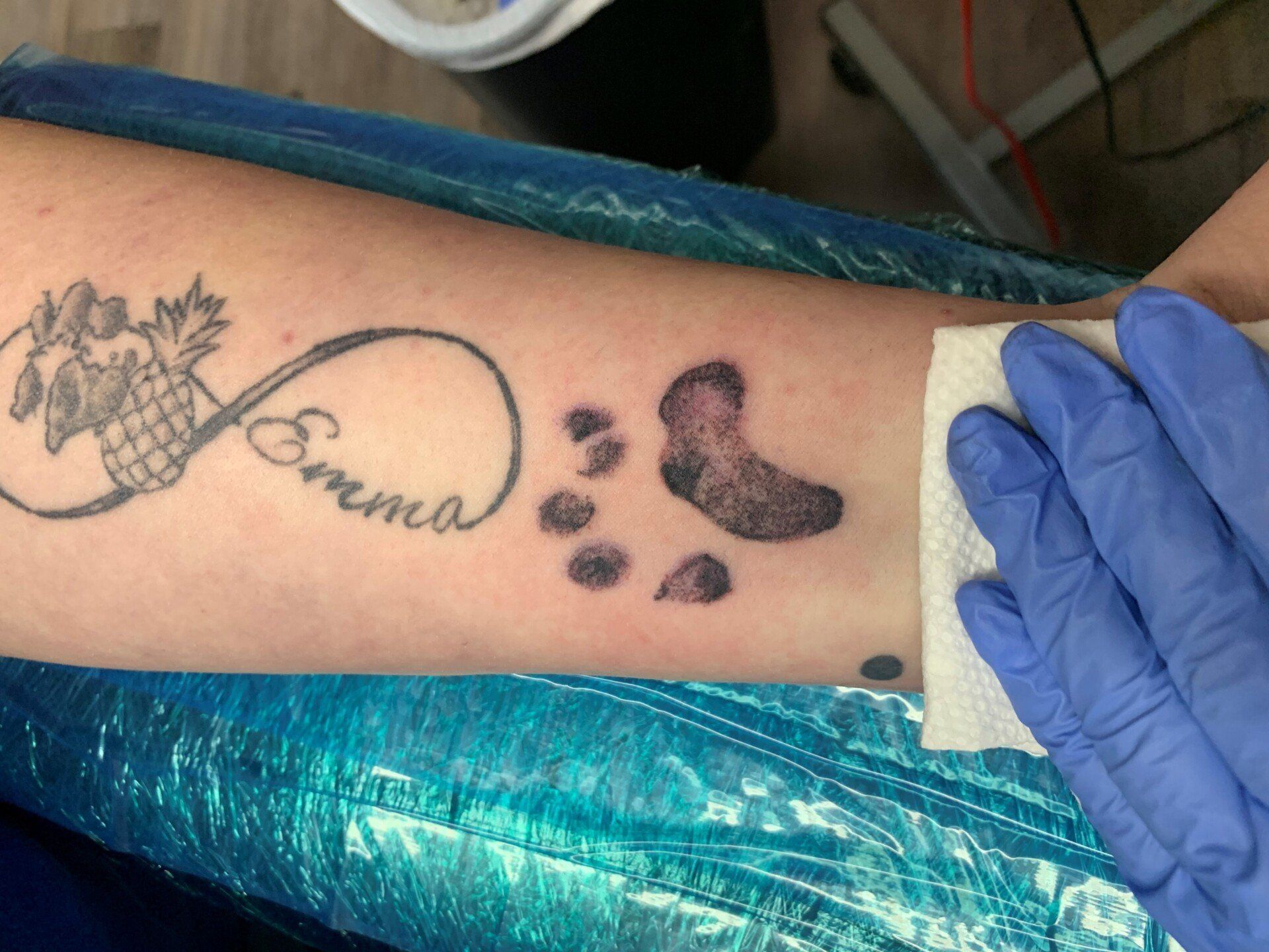 A person has a tattoo on their arm that says emma