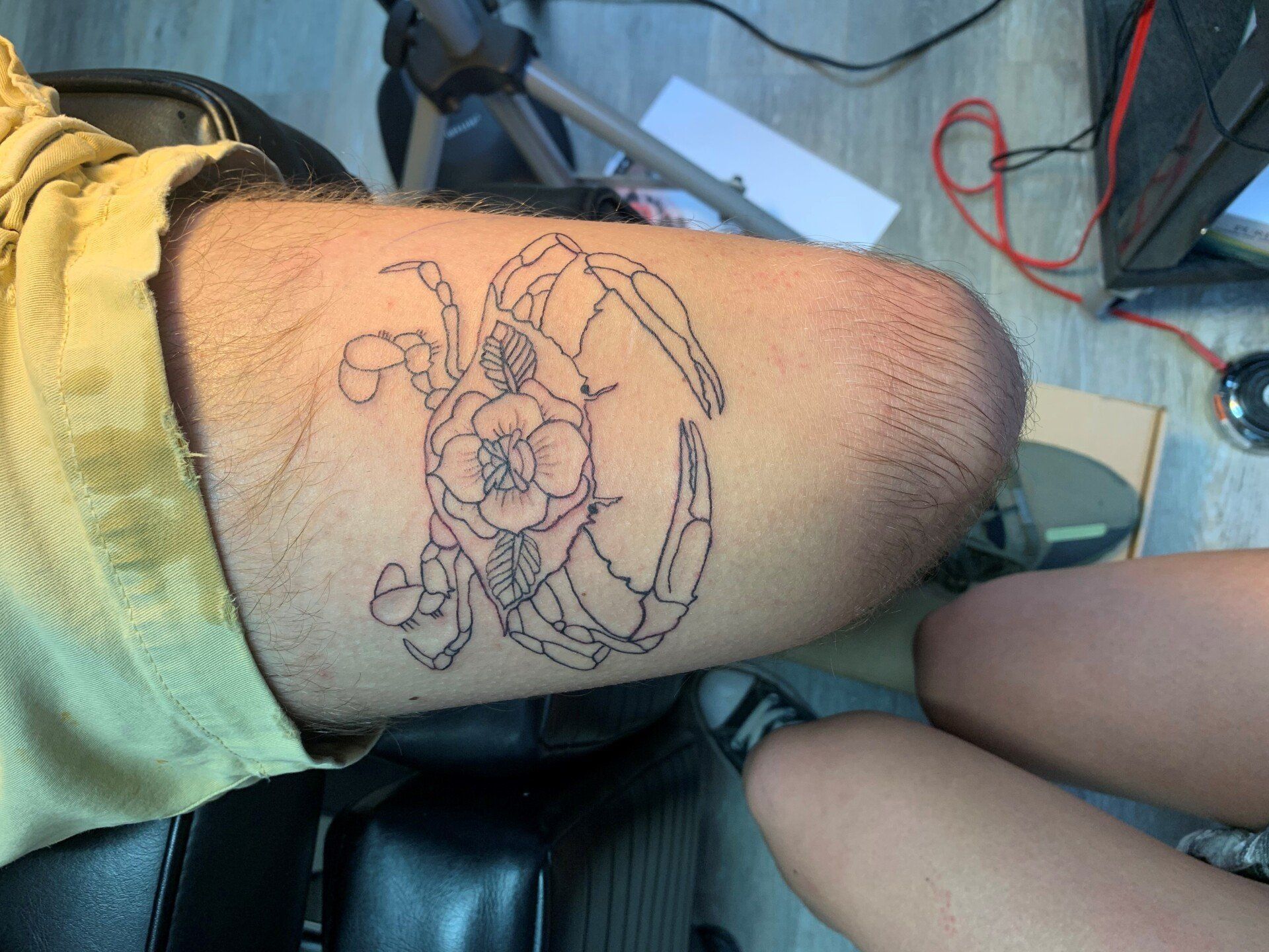 A person has a tattoo of a crab on their leg.