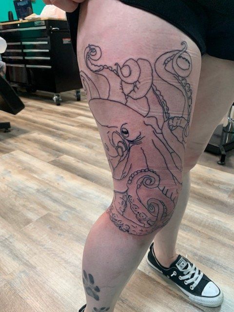 A woman has an octopus tattoo on her leg
