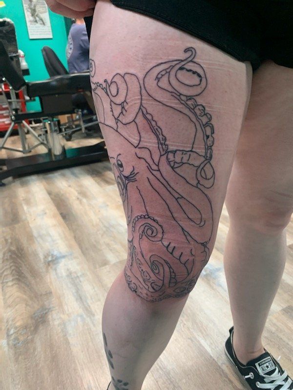 A woman has an octopus tattoo on her leg