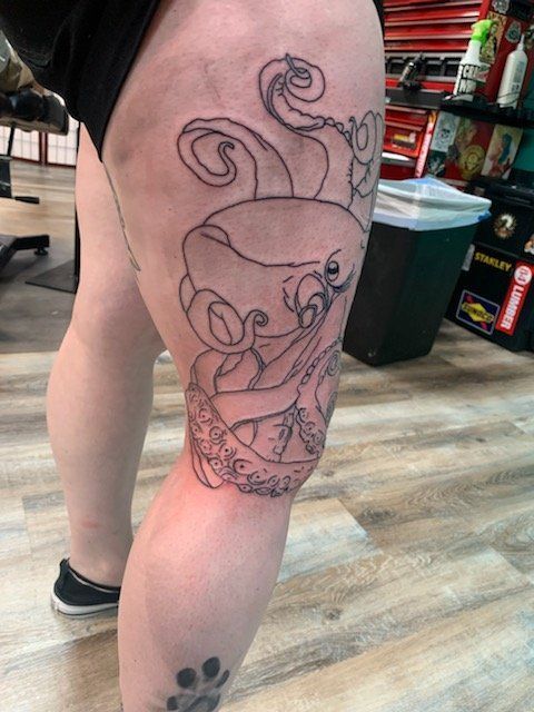 A woman has a tattoo of an octopus on her leg.