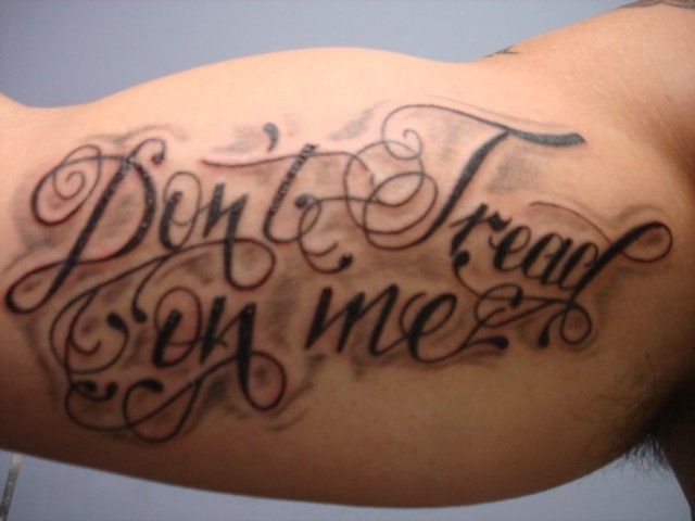 A man has a tattoo on his arm that says 