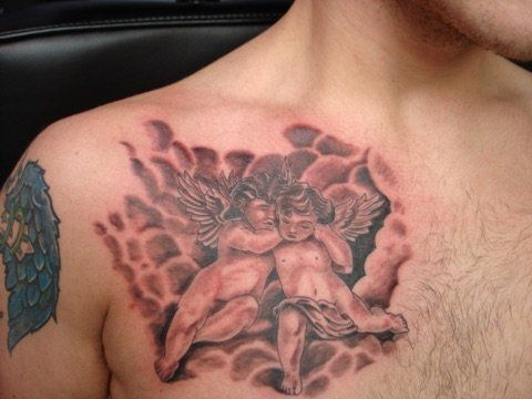 A man has a tattoo of two cherubs on his chest