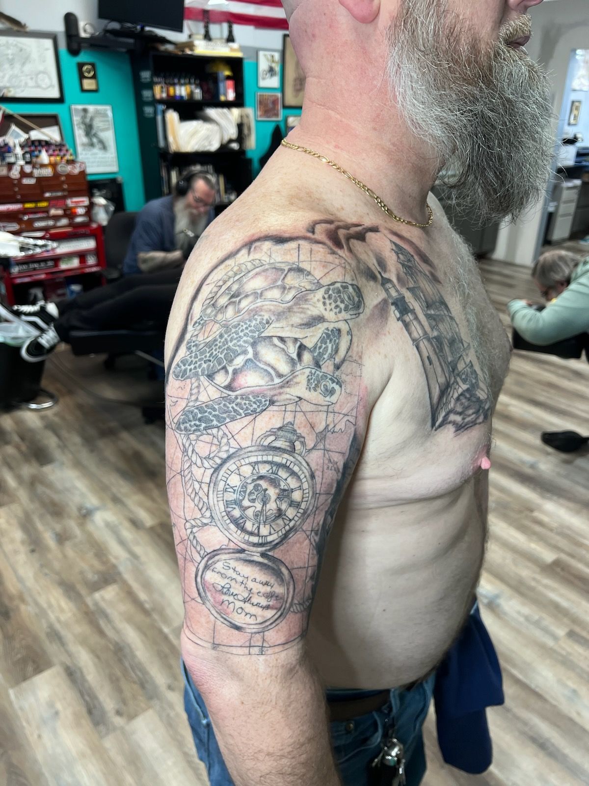 A man with a beard has a tattoo on his arm.