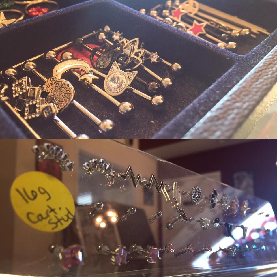 A display of jewelry with a yellow sign that says 