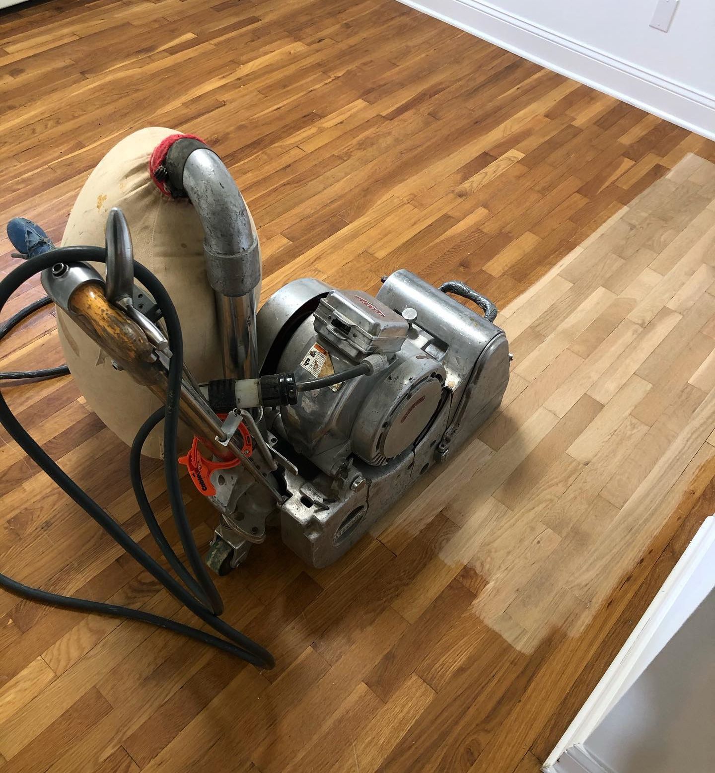 A machine is sitting on top of a wooden floor.