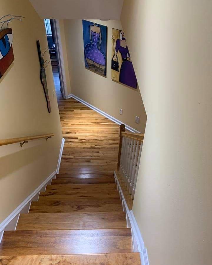 A set of wooden stairs leading up to the second floor of a house.