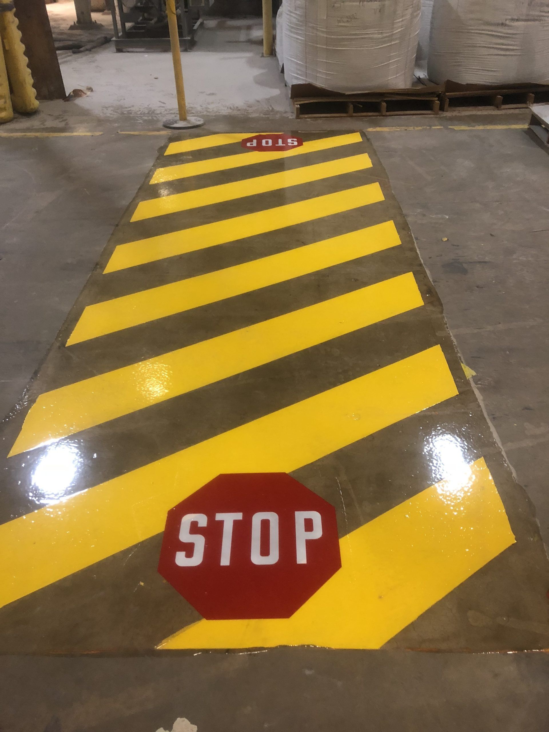 Yellow and black striped floor marking with red 