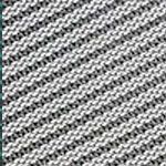 A close up of a knitted fabric with a black and white pattern.
