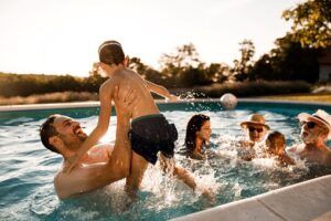 A group of people are playing in a swimming pool.