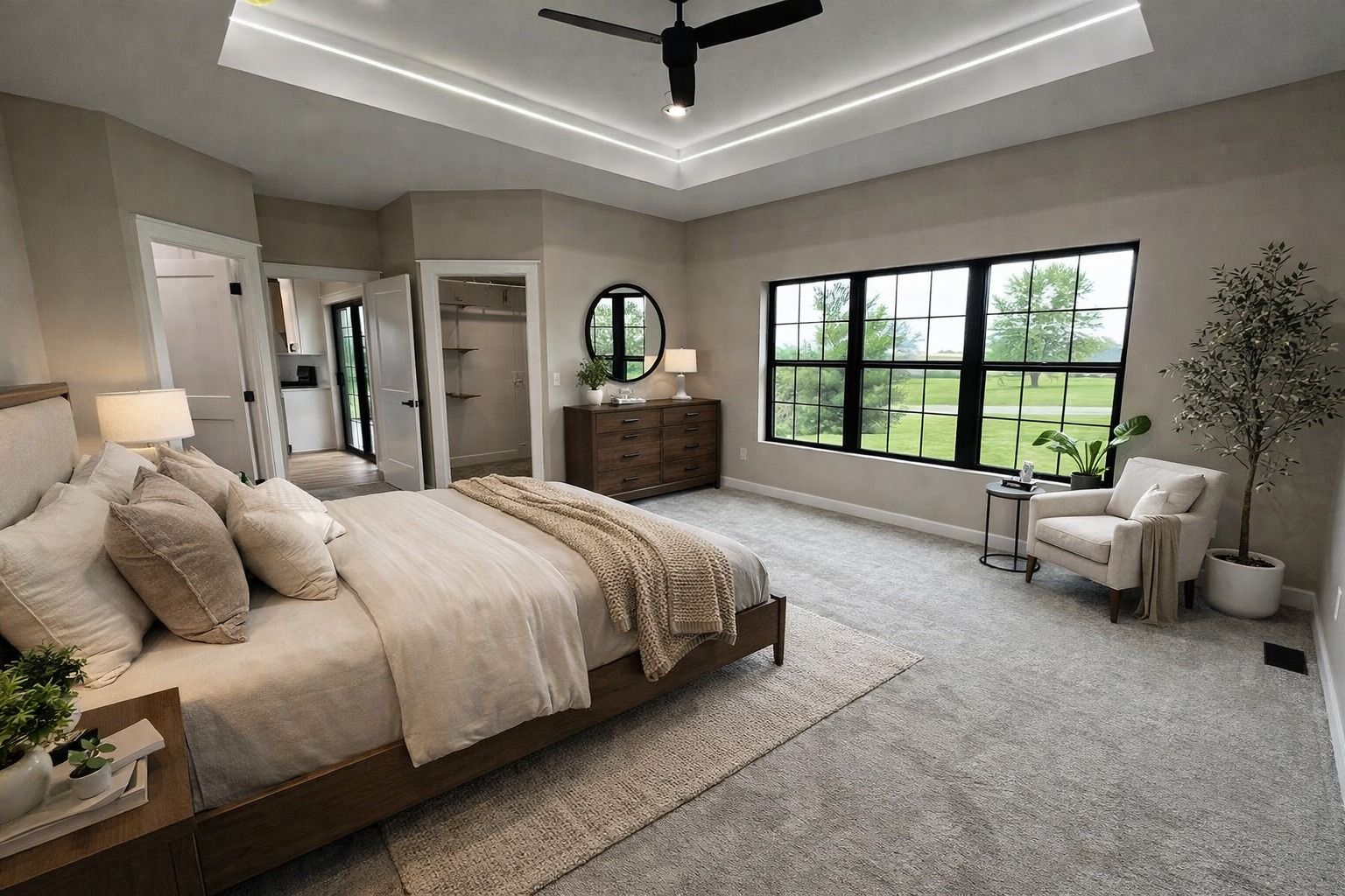 Spacious modern bedroom with king bed, gray carpet, large windows, and a dresser by the wall.