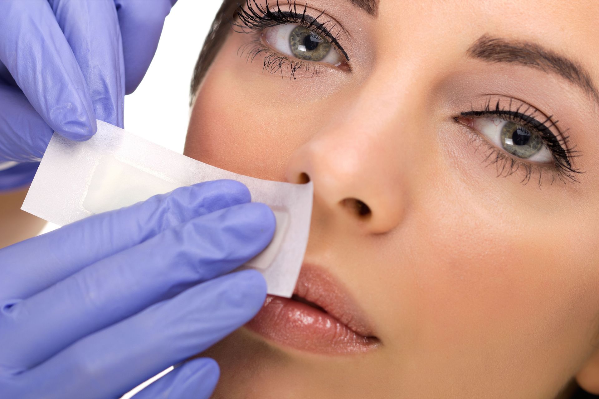 woman receiving lip waxing service