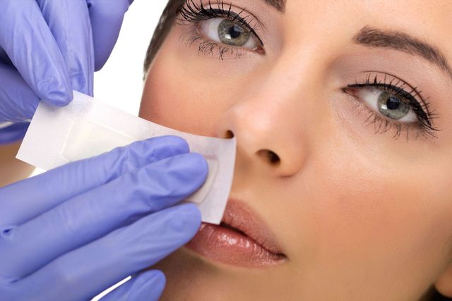 woman receiving lip waxing service