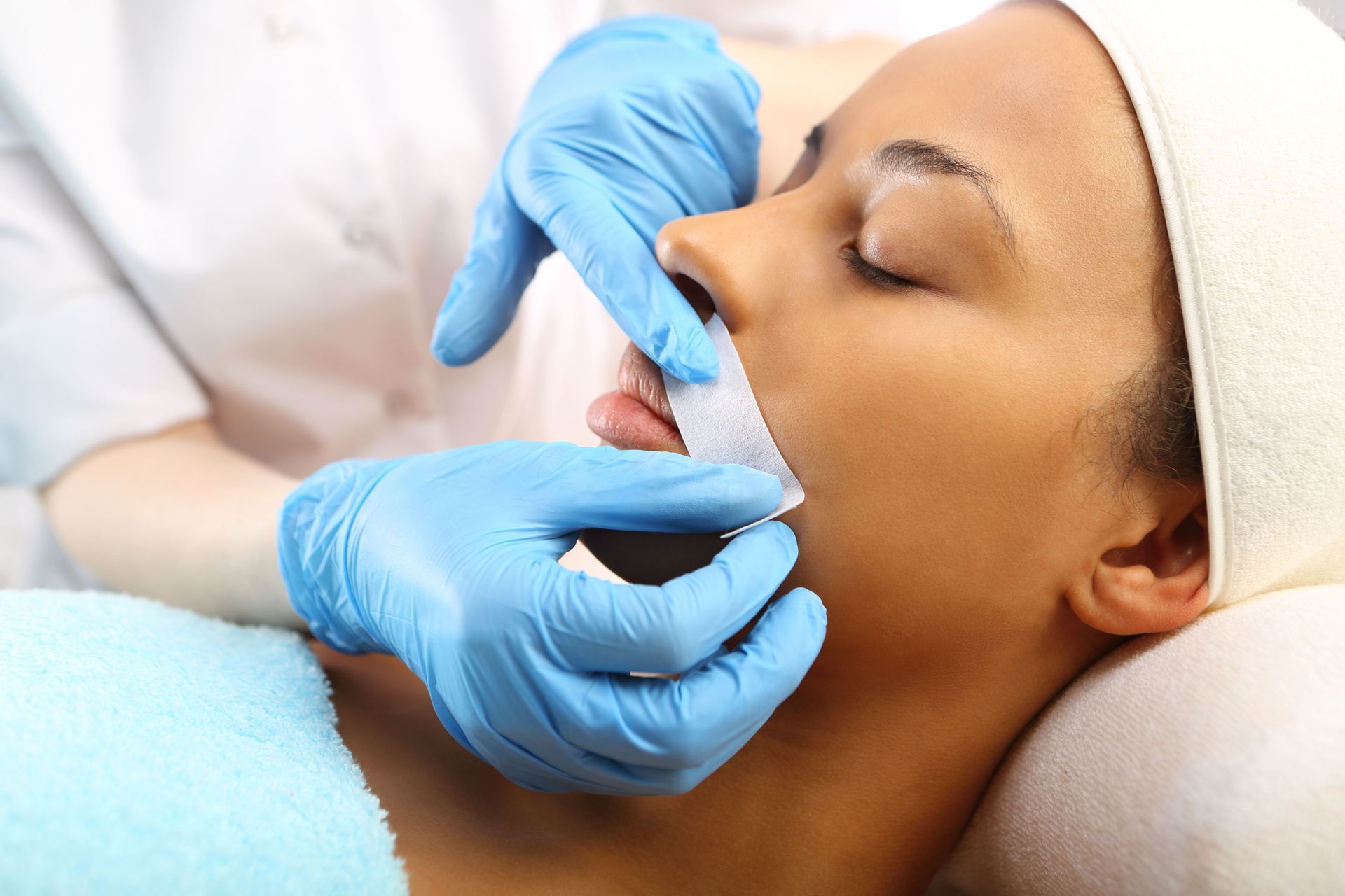 woman receiving lip waxing service
