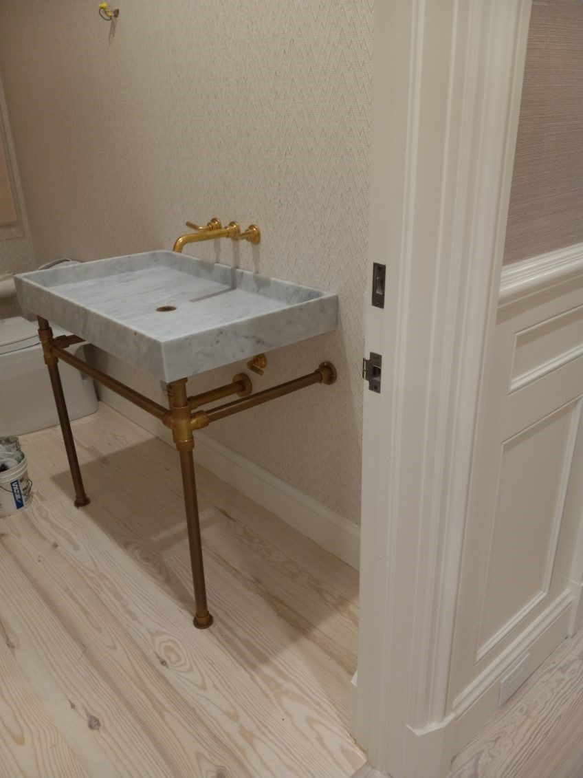 A bathroom with a sink and a door.