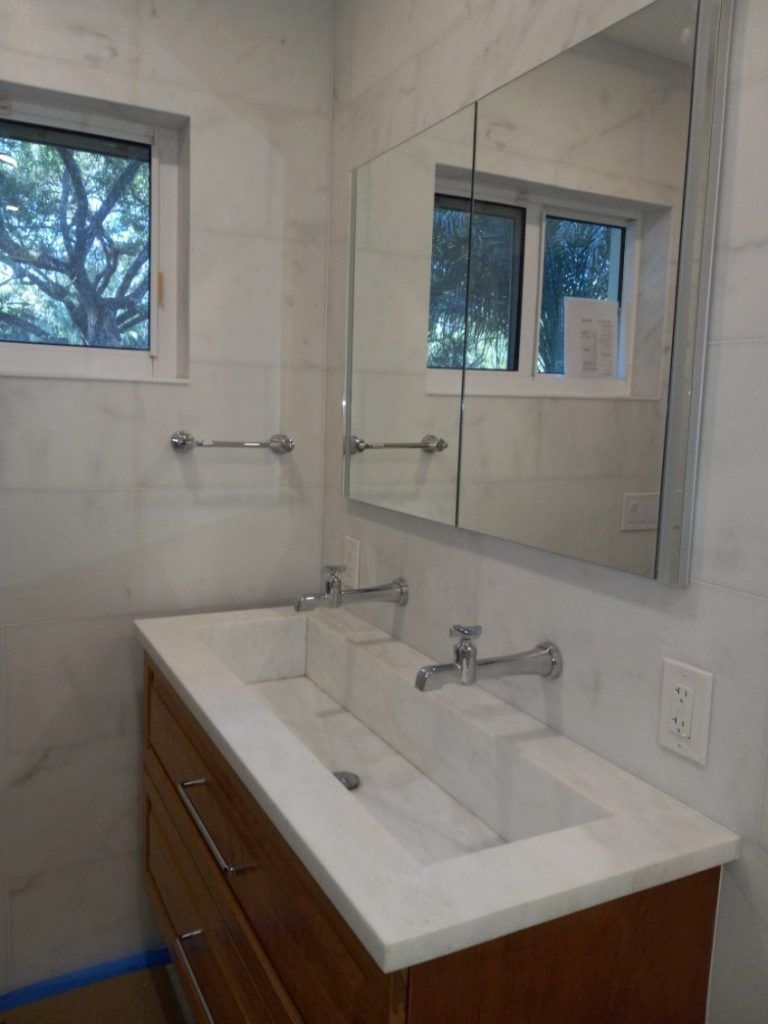 A bathroom with two sinks and a mirror