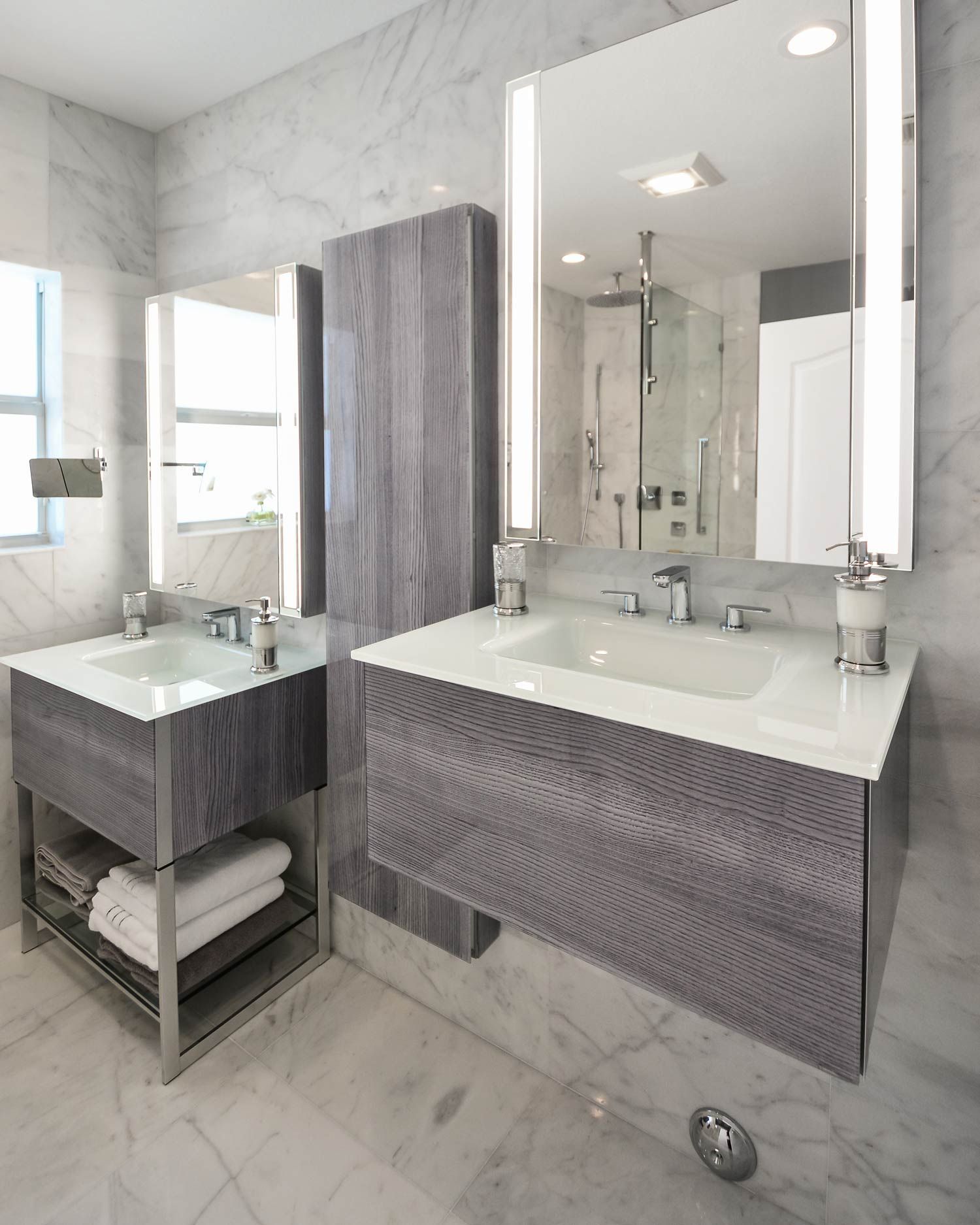 A bathroom with two sinks and two mirrors