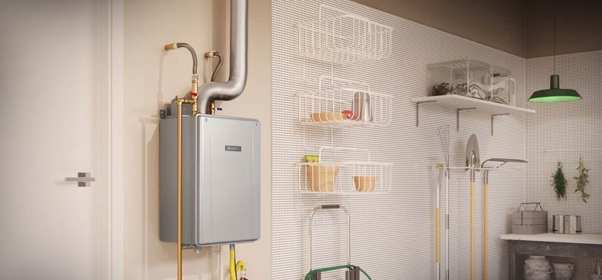 A water heater is hanging on a wall in a garage.