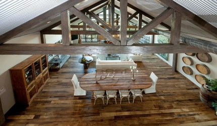 An aerial view of a dining room with a wooden table and chairs