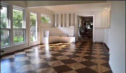 A living room with a checkered floor and lots of windows