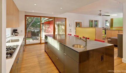 A kitchen with a large island and a sink