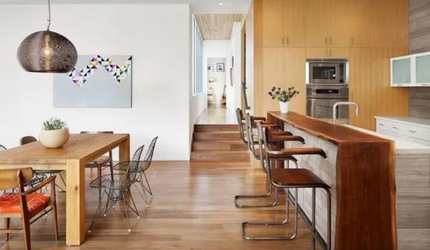 A kitchen and dining room with a wooden table and chairs