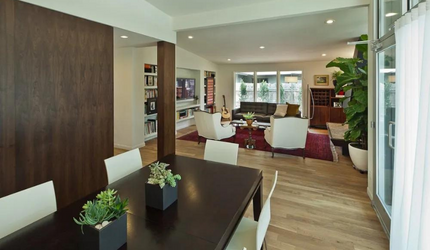 A living room with a dining table and chairs