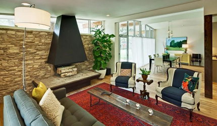 A living room with a couch and chairs and a fireplace