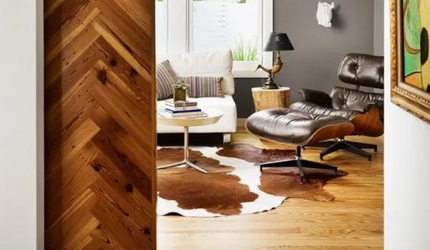 A living room with a cowhide rug and a chair