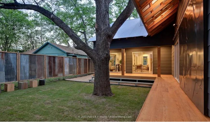 A house with a large tree in front of it